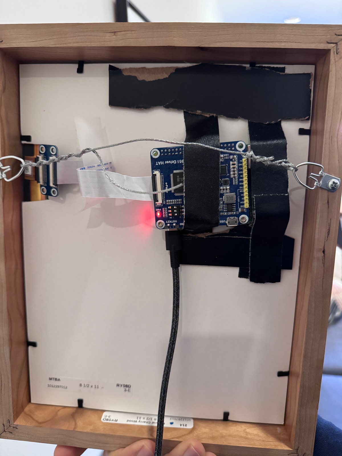 Back of the frame showing Raspberry Pi and wiring